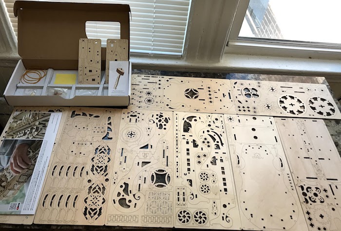 A boxed UGears hurdy-gurdy kit, with all the pieces shown