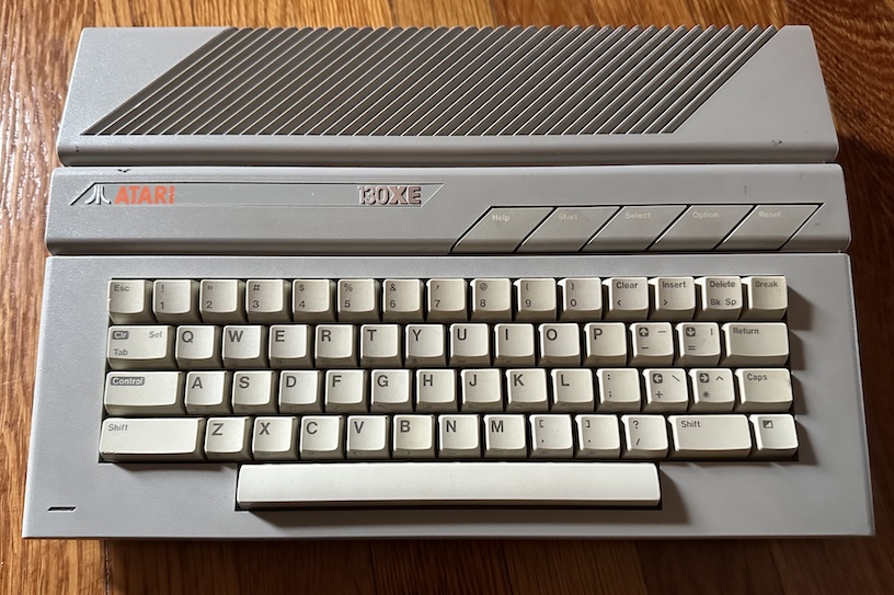 The Atari XE130 sitting on a hardwood floor