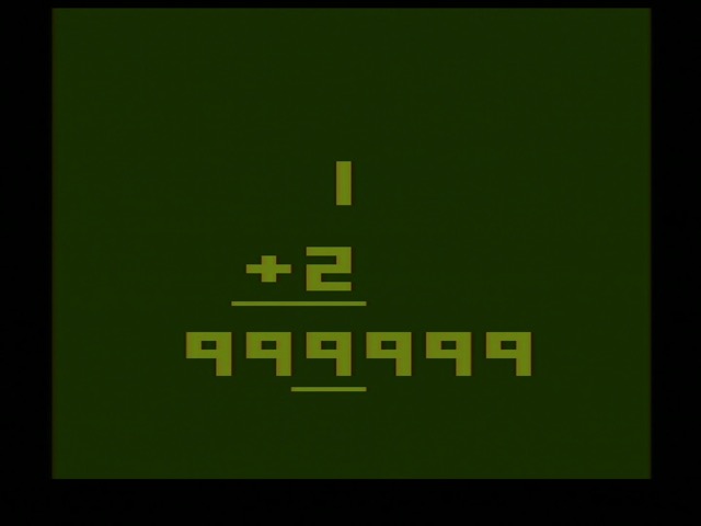 Basic Math on the Atari 2600. In color, 1 + 2, with 999999 below